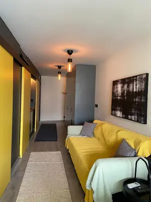 a living room with a yellow bed and a couch at Casa Anibal artistic Centrally located comfortable affordable in Porto