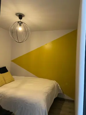 a bedroom with a white bed and a yellow wall at Casa Anibal artistic Centrally located comfortable affordable in Porto