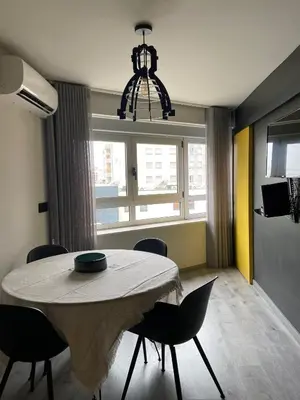 a dining room with a table and chairs and a window at Casa Anibal artistic Centrally located comfortable affordable in Porto