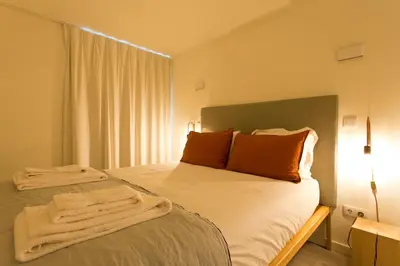 a living room with a couch and a table at Zen Garden Studio B in Porto