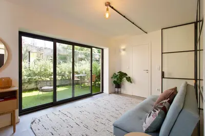 a white bed in a room with a window at Zen Garden Studio A in Porto