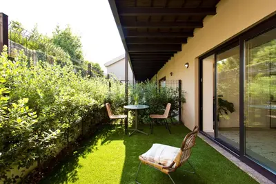 a table with two chairs and a table with wine glasses at Zen Garden Studio A in Porto