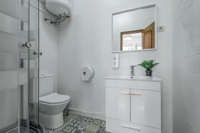 a bathroom with a toilet and a sink and a mirror at Travel & Live Alegria 248 in Porto