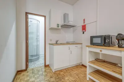 a small kitchen with a microwave and a counter at Travel & Live Alegria 248 in Porto