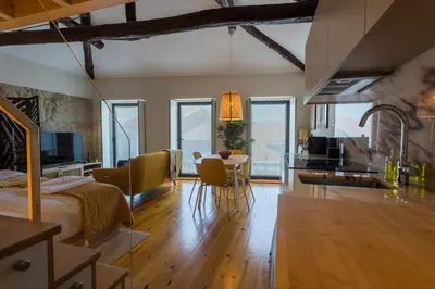 a room with a bed and a kitchen with a table at OPO Bonjardim 902 I in Porto