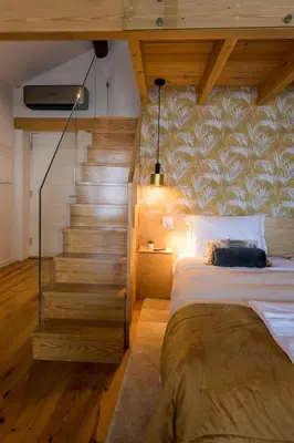 a bedroom with a bed and a stair case at OPO Bonjardim 902 I in Porto