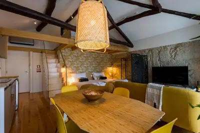 a dining room with a table and a bedroom at OPO Bonjardim 902 I in Porto