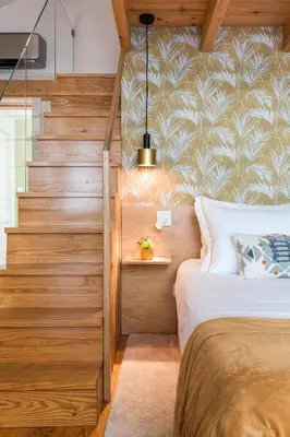a bedroom with a bed and a staircase at OPO Bonjardim 902 I in Porto
