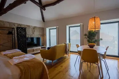a bedroom with a bed and a table and chairs at OPO Bonjardim 902 I in Porto