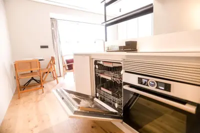a kitchen with an open oven in a room at Alegria Suítes By Porto City Hosts in Porto
