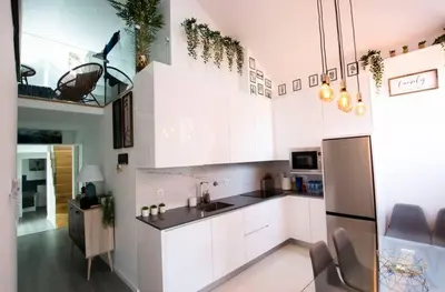 a kitchen with white cabinets and a stainless steel refrigerator at LUXURY PENTHOUSE - River Gallery Art - View&Center in Vila Nova de Gaia