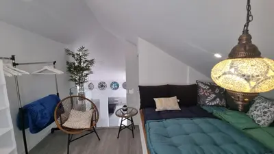 a living room with a blue couch and a chandelier at LUXURY PENTHOUSE - River Gallery Art - View&Center in Vila Nova de Gaia