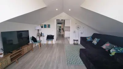 a living room with a couch and a flat screen tv at LUXURY PENTHOUSE - River Gallery Art - View&Center in Vila Nova de Gaia
