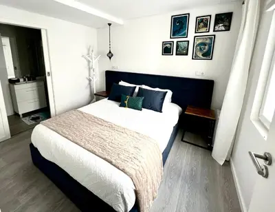 a bedroom with a large bed with blue and white sheets at LUXURY PENTHOUSE - River Gallery Art - View&Center in Vila Nova de Gaia