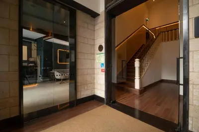 a lobby with a couch and chairs and a mirror at Axis Porto Club Aliados in Porto