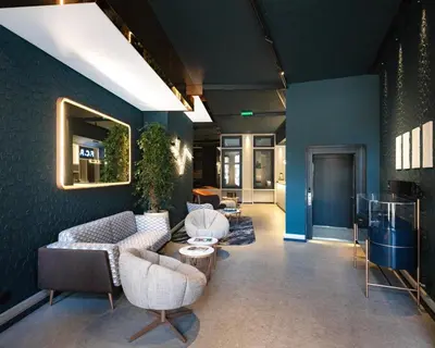 a salon with blue walls and a counter and chairs at Axis Porto Club Aliados in Porto