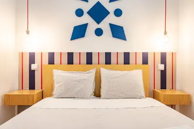 a bedroom with a bed with two night stands at VIVA Trindade Downtown in Porto