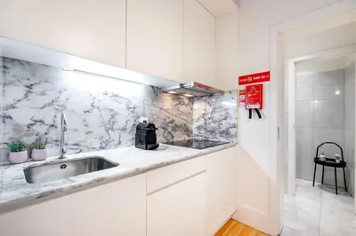 a kitchen with a sink and a counter top at VIVA Trindade Downtown in Porto