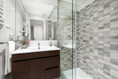 a bathroom with a sink and a glass shower at VIVA Trindade Downtown in Porto