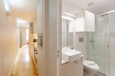 a white bathroom with a sink and a toilet at D&S - JB Apartments in Porto