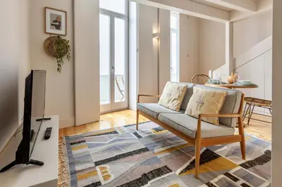 a living room with a couch and a tv at D&S - JB Apartments in Porto