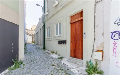 an alley with a red door on a building at D&S - JB Apartments in Porto