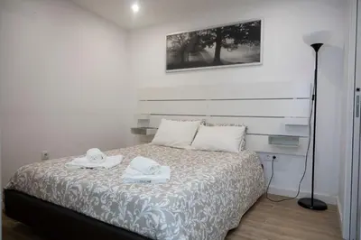 a bedroom with a bed with two towels on it at Oporto Mi House in Porto