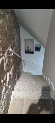 a staircase with a stone wall next to a stair case at Oporto Mi House in Porto
