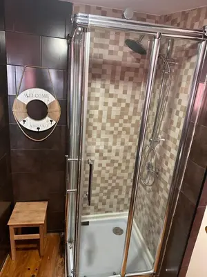 a bathroom with a shower with a glass door at AL Pitões in Porto