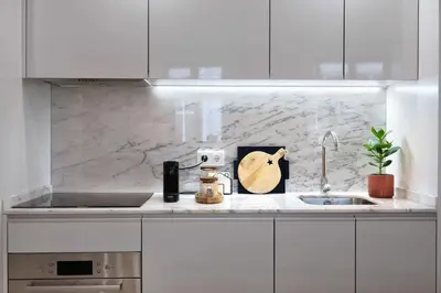a kitchen counter with a sink and a guitar on it at Away to Discover Apartment - hapiness has a place in Porto
