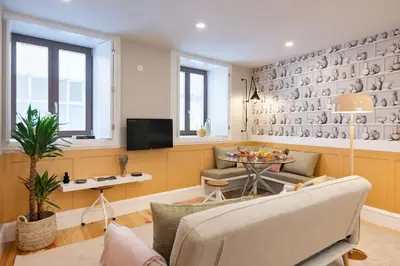 a living room with a couch and a table at Away to Discover Apartment - hapiness has a place in Porto