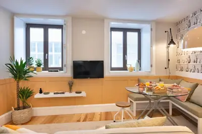 a living room with a couch and a table at Away to Discover Apartment - hapiness has a place in Porto