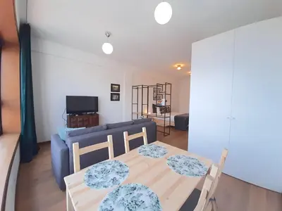 a living room with a table and a blue couch at Porto Vista II by Flat in Porto in Porto