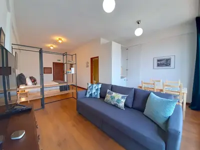 a living room with a blue couch with pillows on it at Porto Vista II by Flat in Porto in Porto
