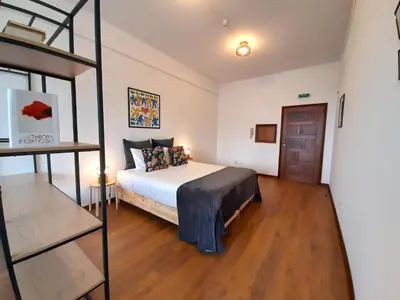 a large bedroom with a bed and a ladder at Porto Vista II by Flat in Porto in Porto