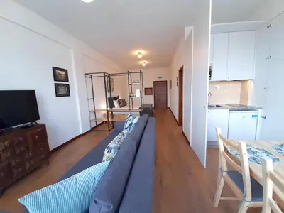a living room with a couch and a kitchen at Porto Vista II by Flat in Porto in Porto