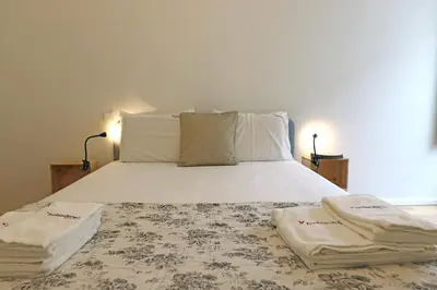 a bedroom with a bed with two towels on it at FLH Gaia Homey Winery Flat in Vila Nova de Gaia