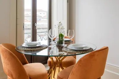 a dining room with a glass table and chairs at Bright Studio near Douro River - with Balcony in Porto
