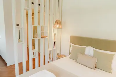 a bedroom with a bed and a lamp at JARS Apartments - Casa do Bessa in Porto