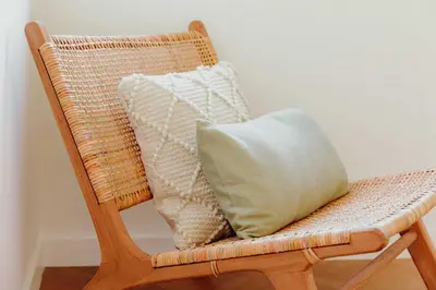 a wicker chair with a pillow on it at JARS Apartments - Casa do Bessa in Porto