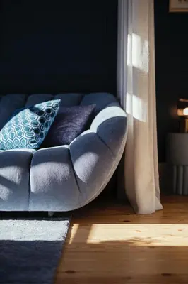 a blue couch with two pillows in a room at As Vizinhas Boutique Apartments in Porto