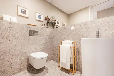 a living room with a kitchen with a counter top at As Vizinhas Boutique Apartments in Porto