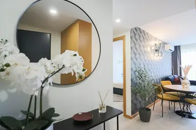 a living room with a round mirror on the wall at HM - ISSY Oporto Apartment in Porto