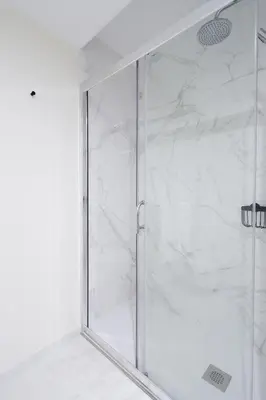 a shower with a glass door in a bathroom at HM - ISSY Oporto Apartment in Porto