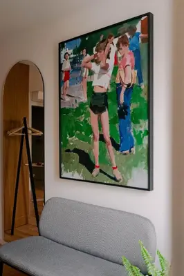 a painting hanging on a wall in a living room at Gharb in Porto