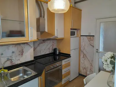 a small kitchen with a sink and a refrigerator at Cozy Central 3 Bedrooms Bragas in Porto