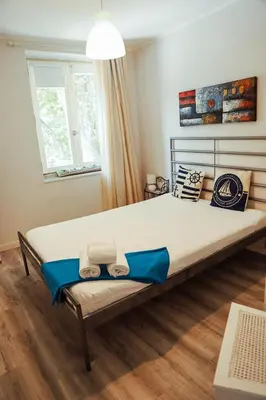 a bedroom with a large bed with two towels on it at Sailor's House 2 - Holiday's House in Porto