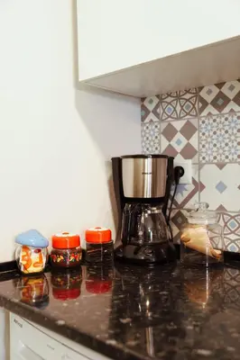 a kitchen with white cabinets and a microwave at Sailor's House 2 - Holiday's House in Porto