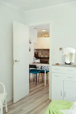 a kitchen with white cabinets and a sink at Sailor's House 2 - Holiday's House in Porto