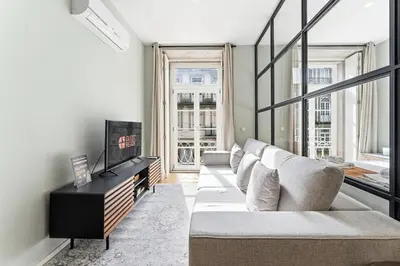 a living room with a couch and some windows at GuestReady - Modern Apartment in Bolhão in Porto
